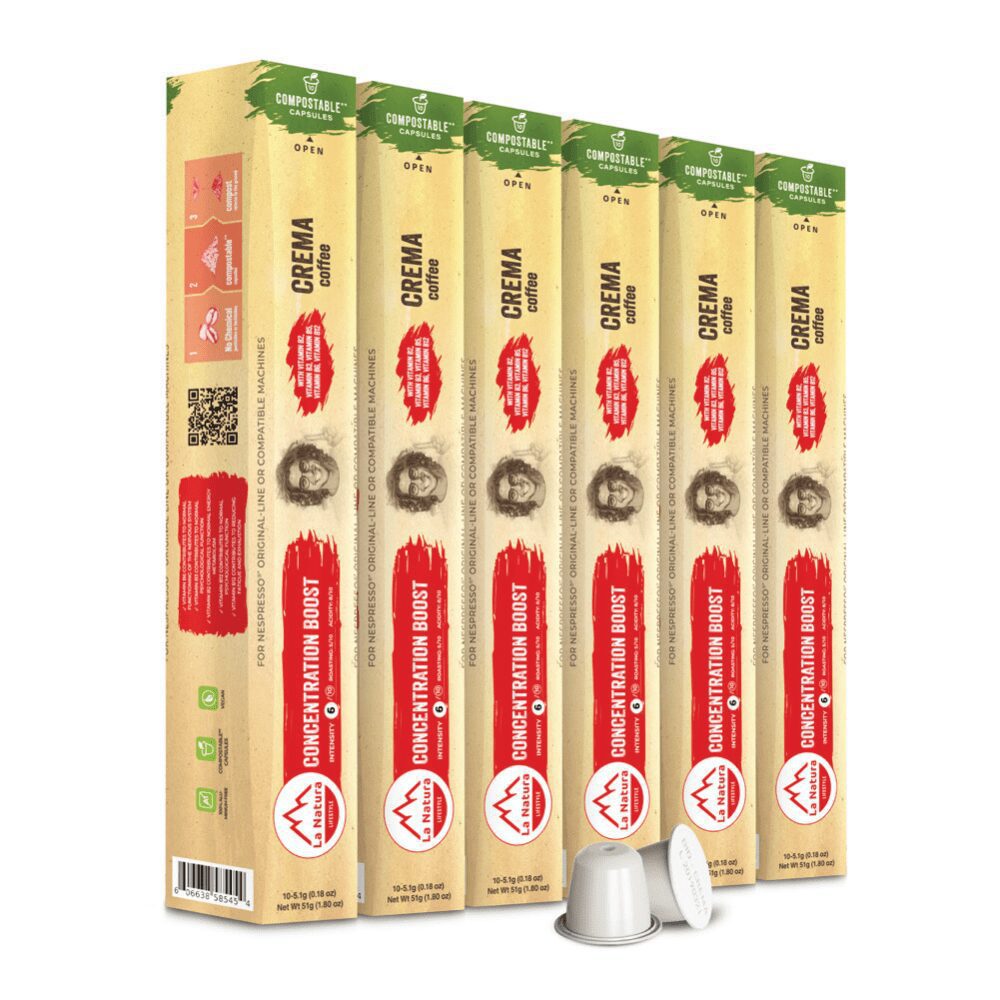 Six vertical boxes of "Crema Coffee" with "Energy Boost" labels, placed side by side. The beige and green packaging with red and black text beautifully showcases the compostable pods inside. Two white coffee capsules are placed in front of the boxes, emphasizing their quality and eco-friendliness.